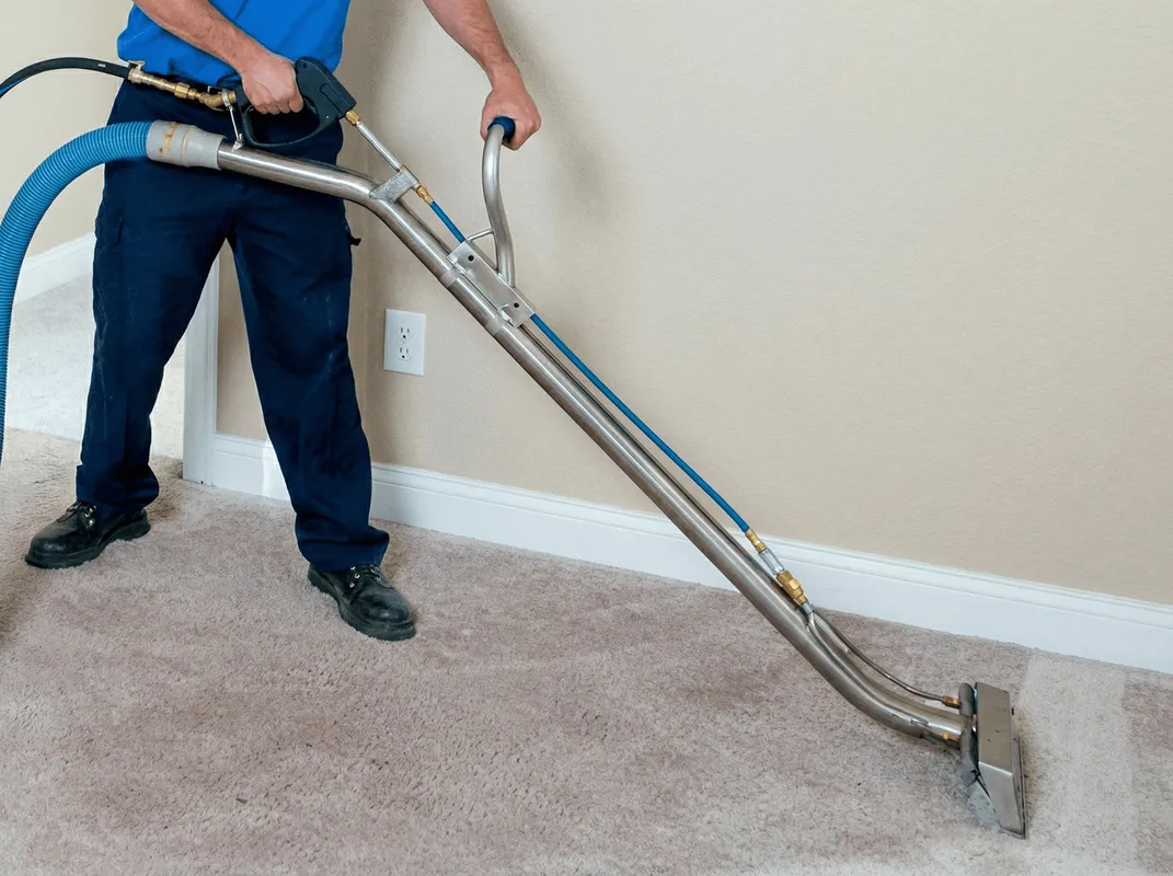 Professional operating a liquid removal machine on a carpeted floor in Memphis, TN